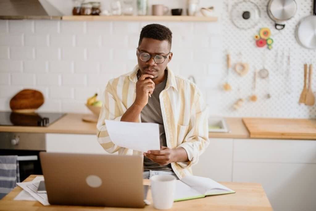 Freelancer reviewing paperwork while working at a desk