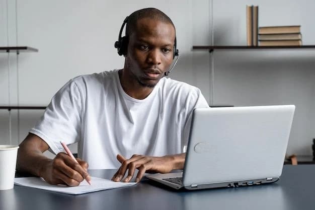 Freelancer writing notes beside a laptop