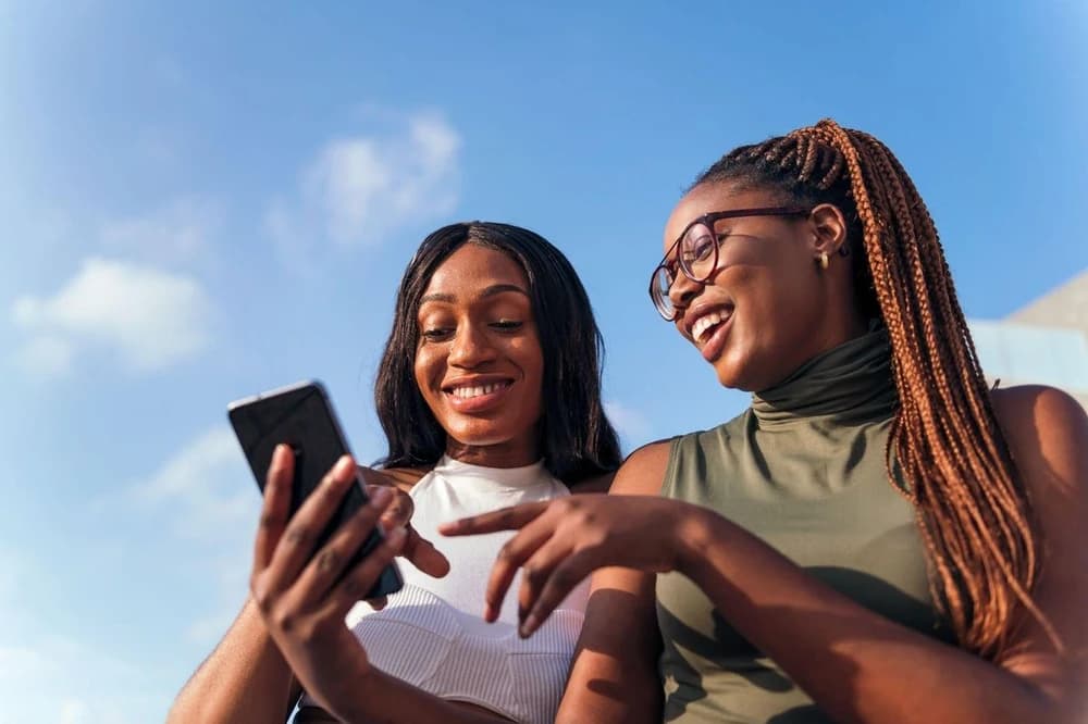 Two professionals reviewing a phone together