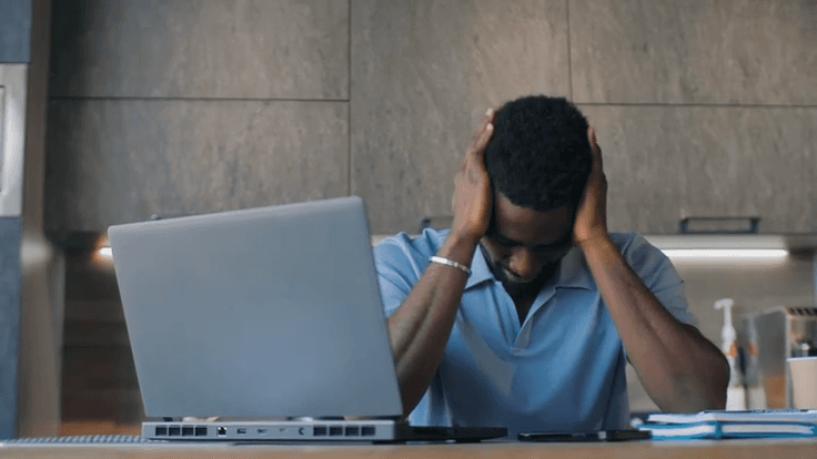 An Employer planning work beside a laptop